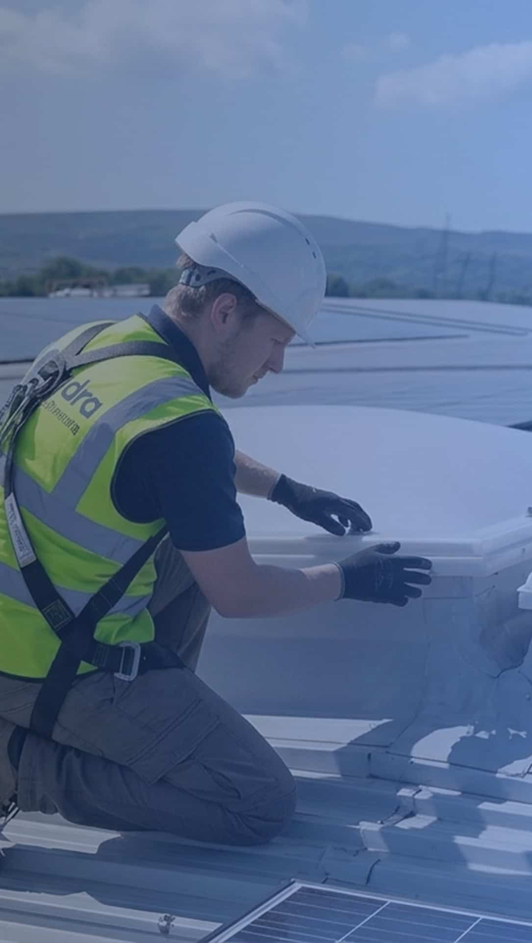 Smoke vent service - maintenance and repairs 1 Specialist in smoke extraction installations fitting equipment on a roof.