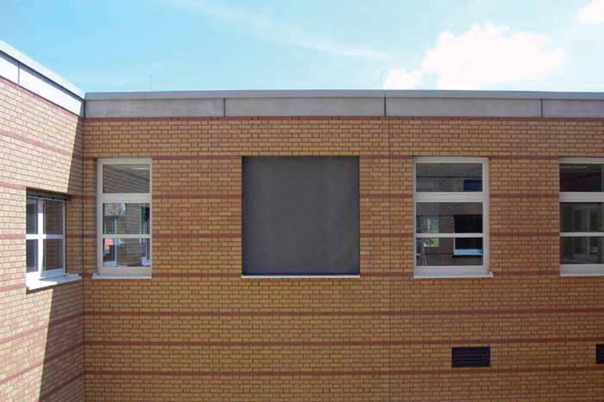 Fire-resistant curtain installed on the façade of a school or office building.