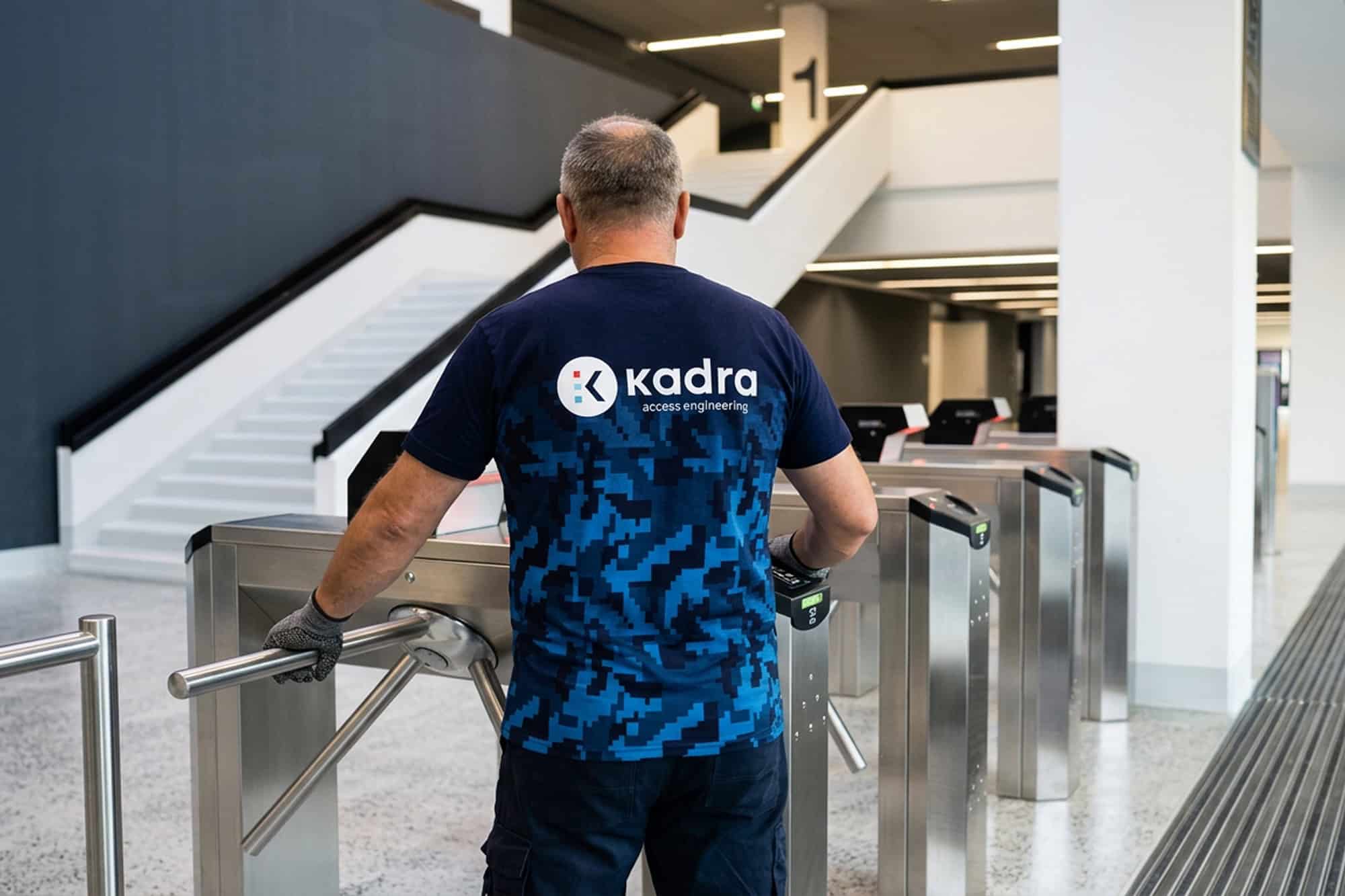 Automatic Door Inspection: What to Check Daily, Seasonally, and Every 6 Months 3 Person using Kadra access control turnstiles inside a modern space.